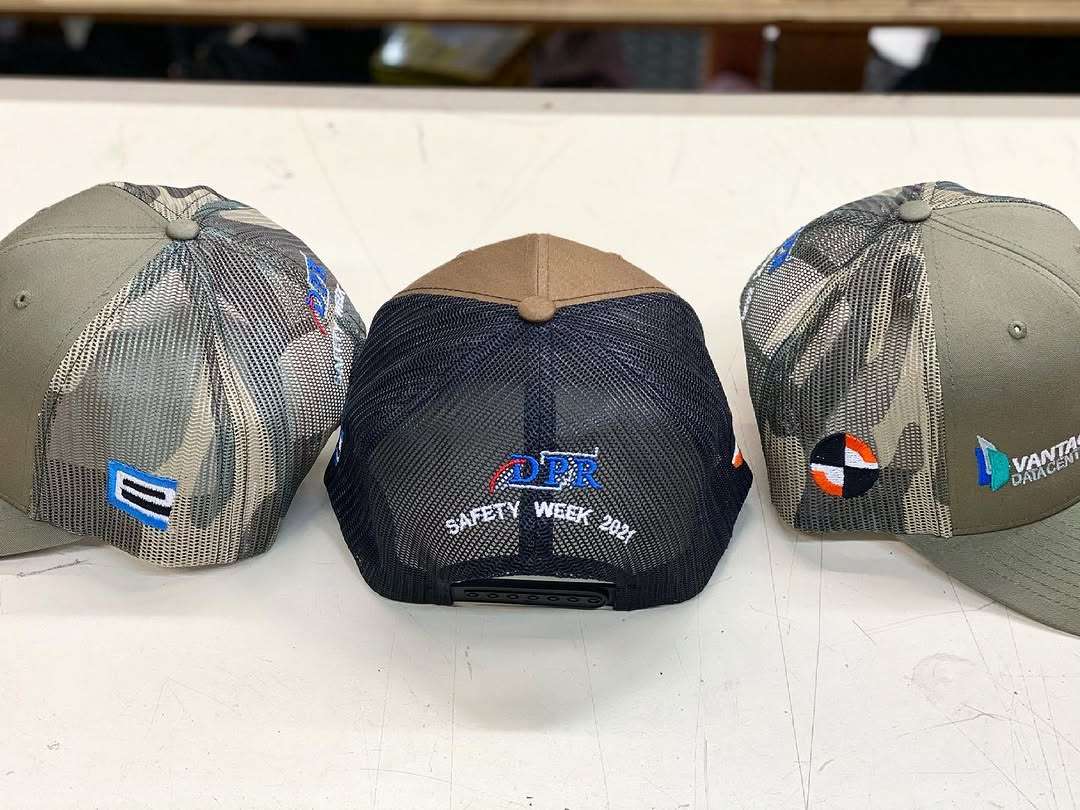 Custom embroidered hats — multi-logo layout sample