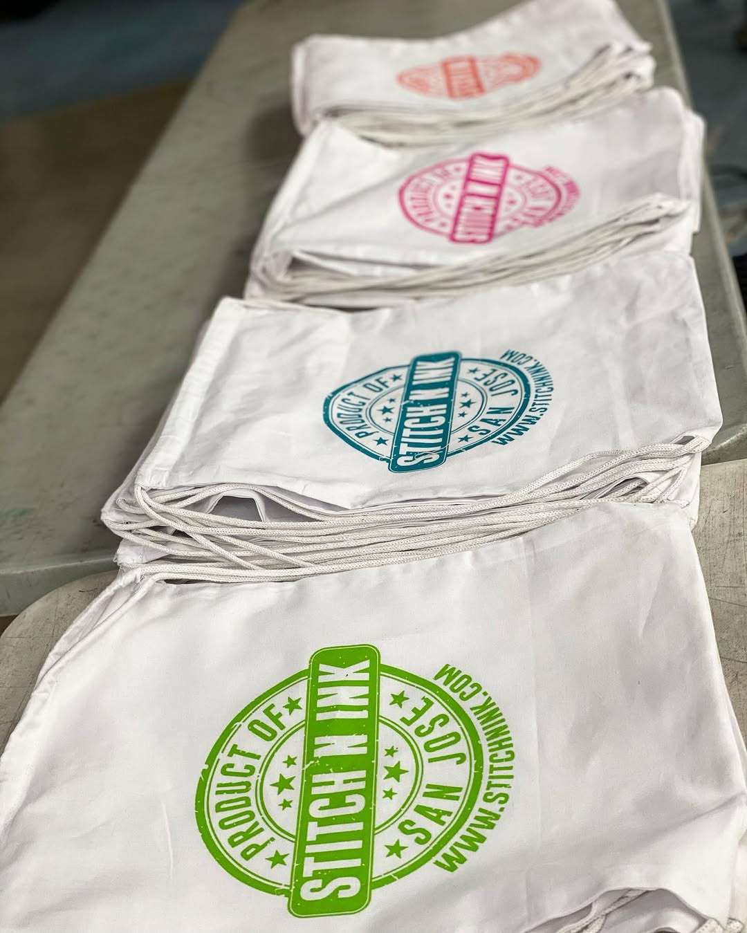 Folded Stitch N Ink merch and bags fresh off the press